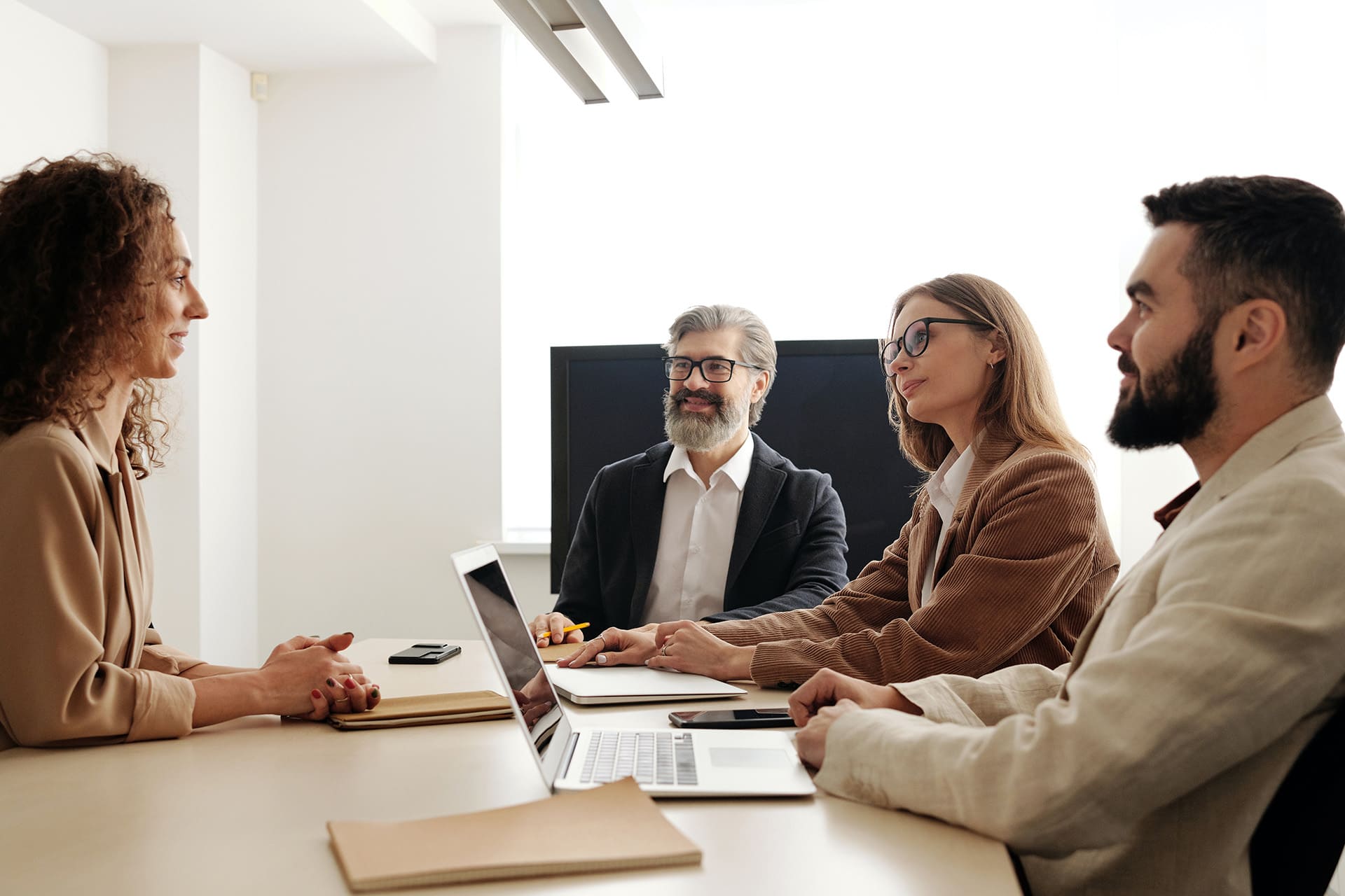 Group of insurance agents discussing bonding and insurance in an office